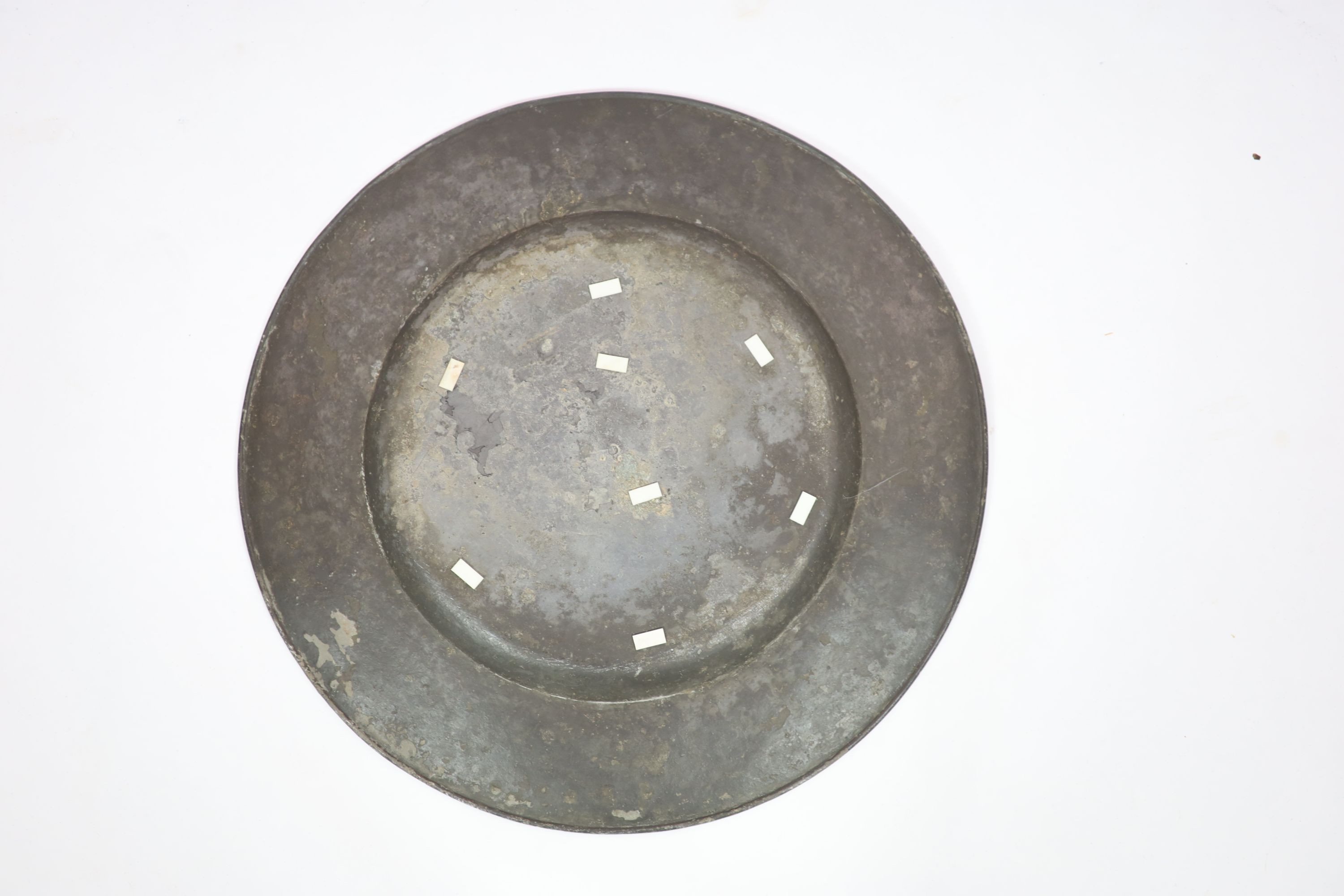 A late 17th century pewter charger of large proportions, the rim with armorial (touchmarks rubbed) 63cm diameter.